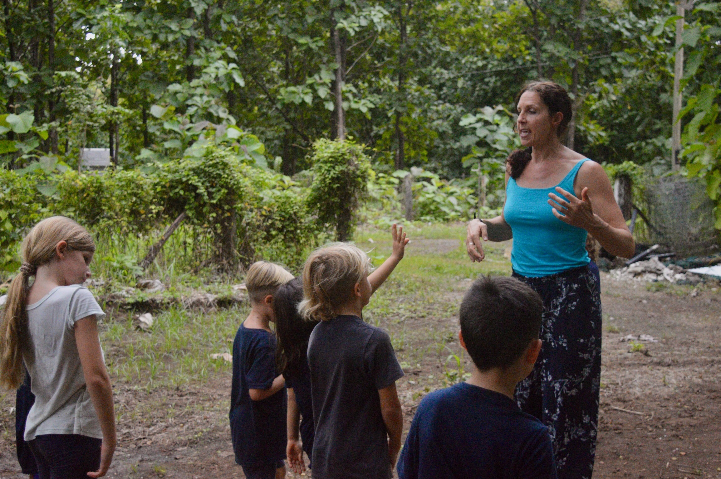 Teacher with students in natural outdoor classroom